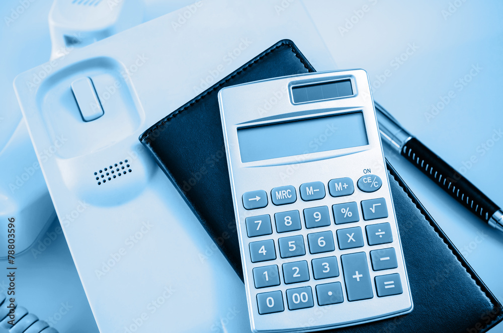 Note book and calculator on telephone Note book and calculator on telephone