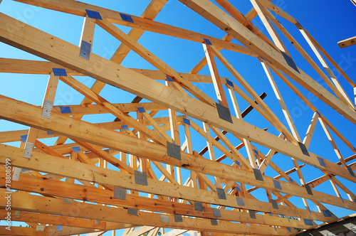 Wooden house construction detail in blue sunny day sky
