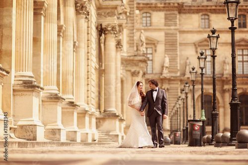 Bride and groom walking in Paris