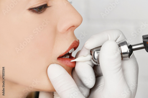 Cosmetologist making perman...