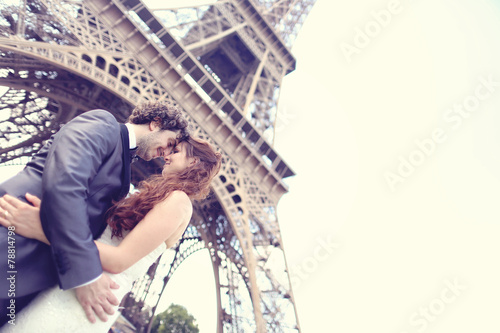 Bride and groom near Eiffel tower photo