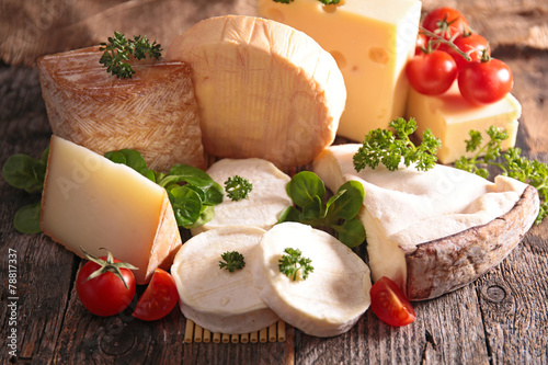 collection of cheese on wood background