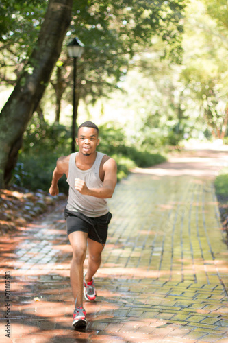 Attractive Black man running, exercising , stretching outside Pa