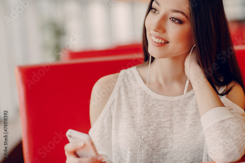 beautiful young girl enjoys phone and tablet