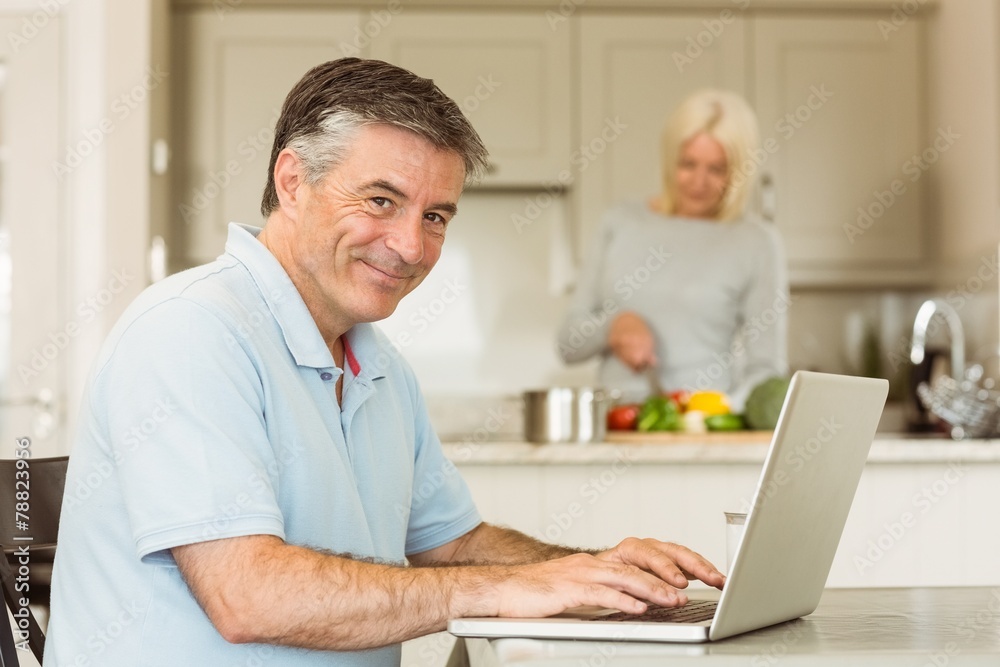 Happy mature man using laptop Happy mature man using laptop