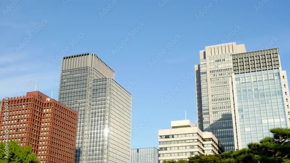 Pan Up of Office Buildings Surrounded by Trees in Central Tokyo Japan Pan Up of Office Buildings Surrounded by Trees in Central Tokyo Japan