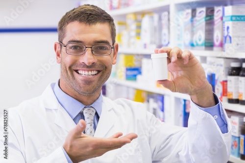 Pharmacist showing medicine jar