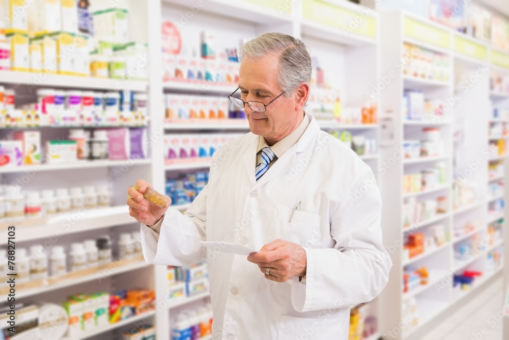 Senior pharmacist looking at medicine and prescription