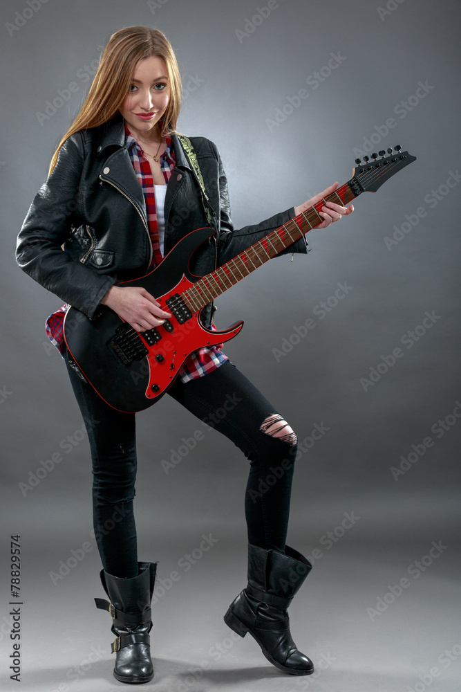 Beautiful young,blond woman with a electric guitar Beautiful young,blond woman with a electric guitar
