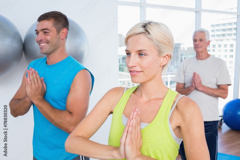 People meditating in fitness club People meditating in fitness club