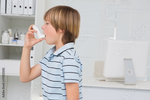 A little boy using inhaler