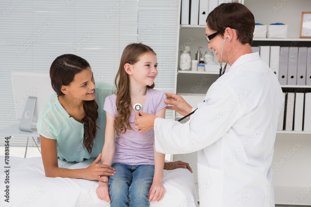 Doctor examining little girl with her mother Doctor examining little girl with her mother