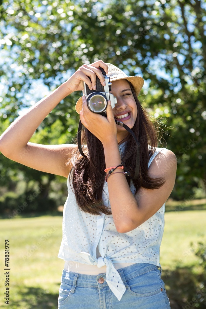 Pretty brunette using retro camera Pretty brunette using retro camera