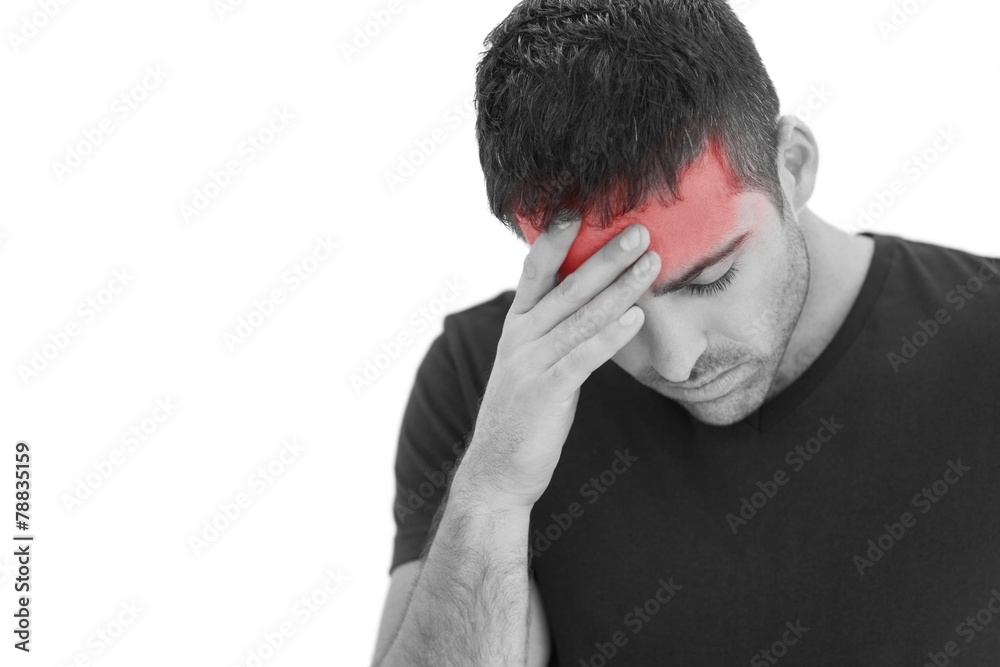 Upset man standing with his hand holding his forehead Upset man standing with his hand holding his forehead