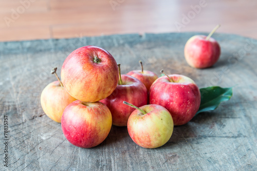 fresh red apples on wooden surface