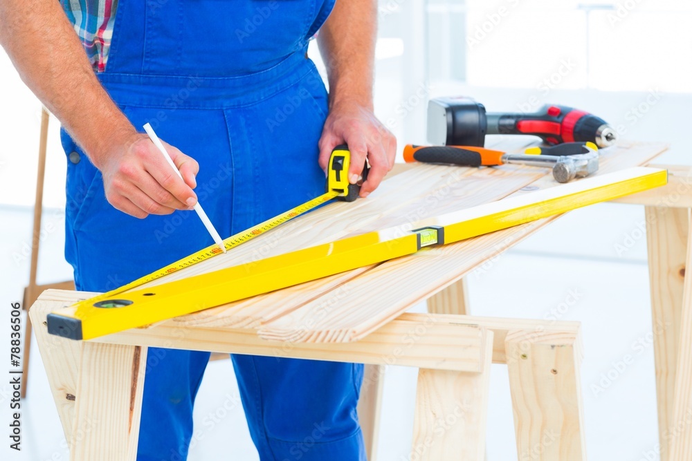 Carpenter working at workbench in office Carpenter working at workbench in office