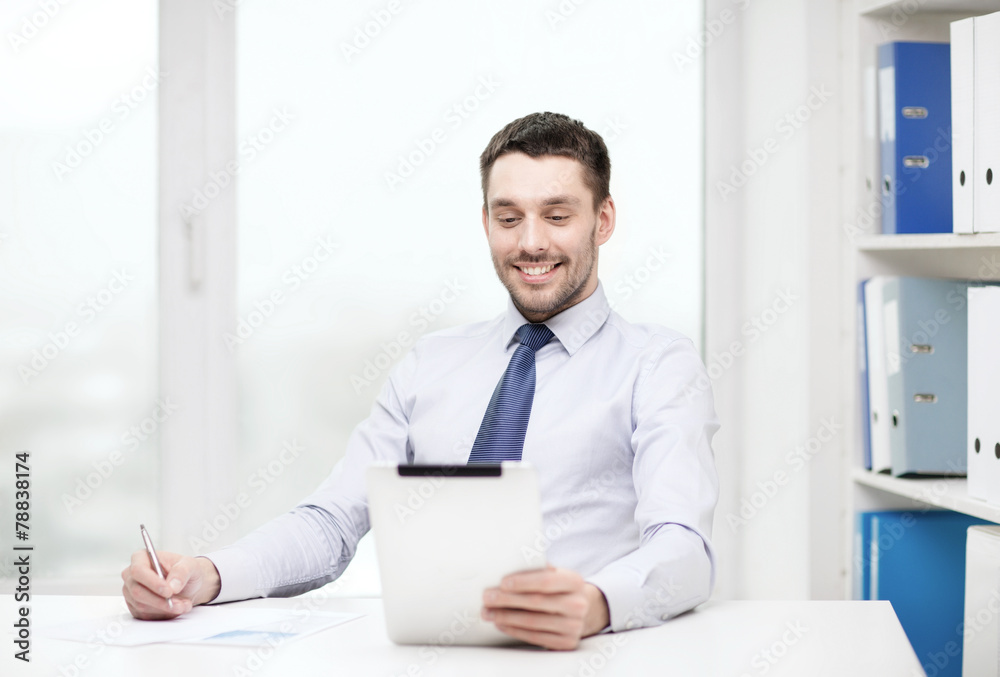 smiling businessman with tablet pc and documents