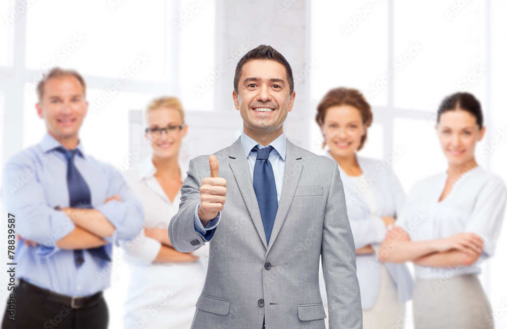 happy businessman in suit showing thumbs up happy businessman in suit showing thumbs up