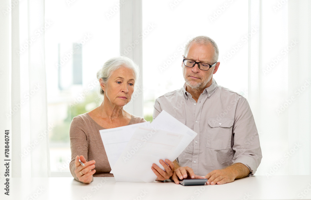 senior couple with papers and calculator at home senior couple with papers and calculator at home