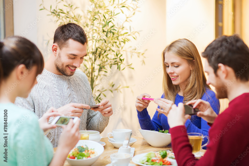 friends with smartphones taking picture of food friends with smartphones taking picture of food