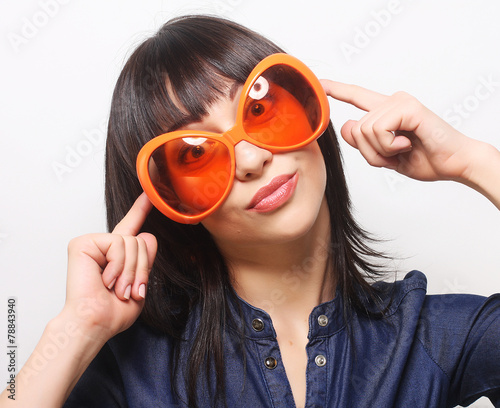 young happy woman with big orange sunglasses