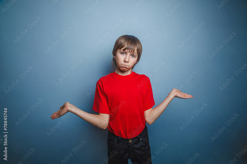 boy, teenager, twelve years in the red shirt spread his hands, t