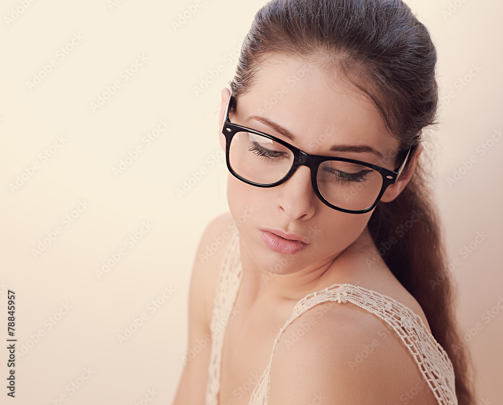 Beautiful woman in glasses looking down. Soft light portrait Beautiful woman in glasses looking down. Soft light portrait