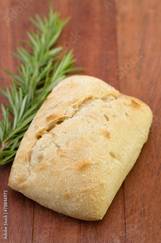 bread with rosemary on brown background
