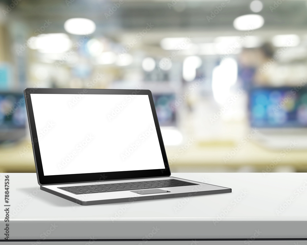 Laptop with blank screen on laminate table and blurred backgroun Laptop with blank screen on laminate table and blurred backgroun