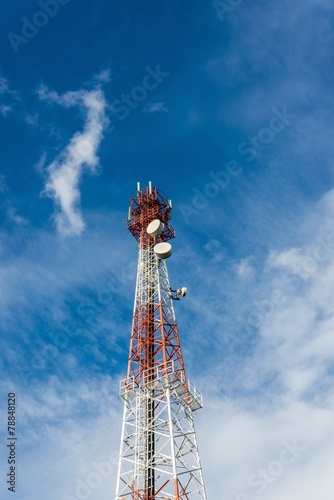 telecommunications tower blue sky cloud background.