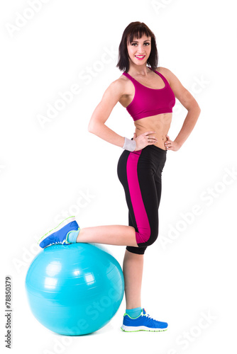 Young smiling woman makes exercise with fitball