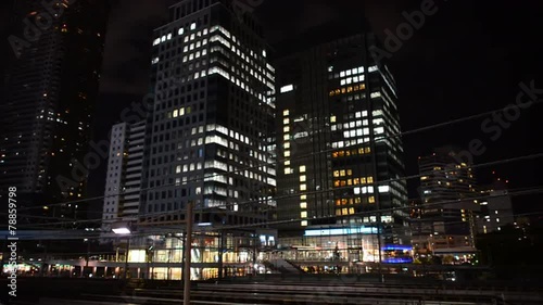 Time Lapse of Train Passing over Bridge in Central Tokyo Japan at Night photo