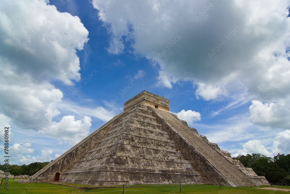 Chichen itza pyramid in a blue sky day back view
