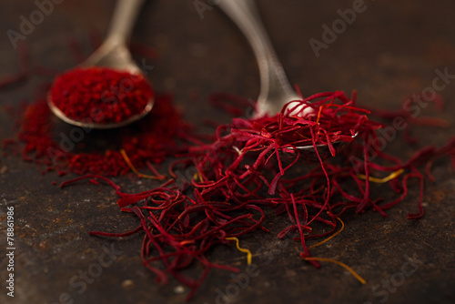 saffron spice threads and powder  in vintage  old spoons photo