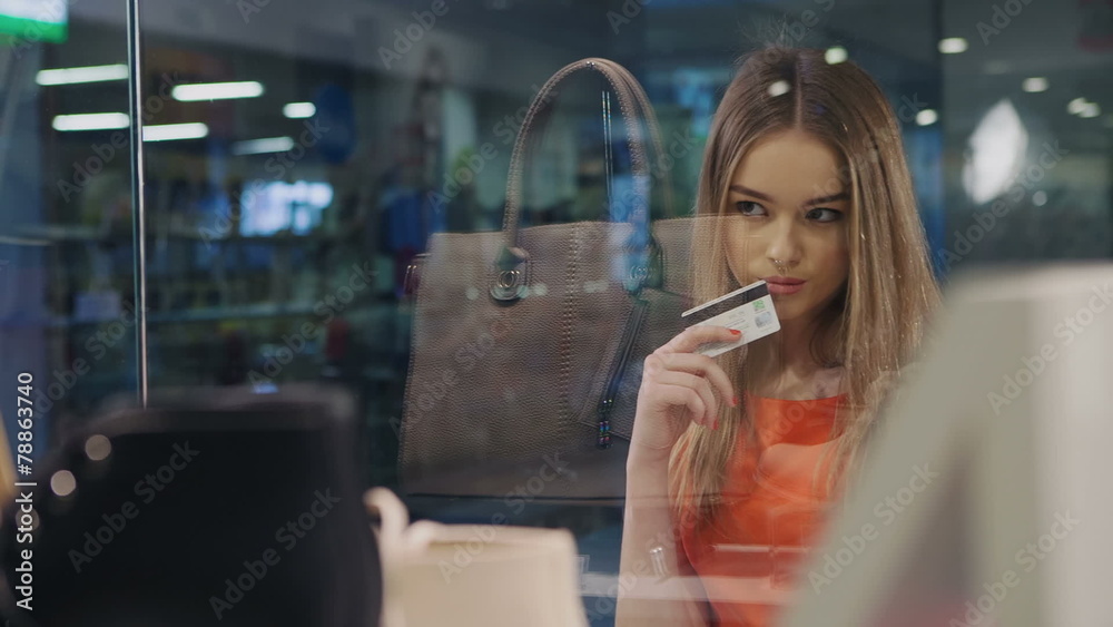 Beautiful young blonde decided to buy goods from storefront