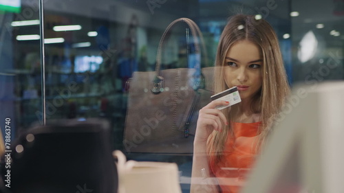 Beautiful young blonde decided to buy goods from storefront