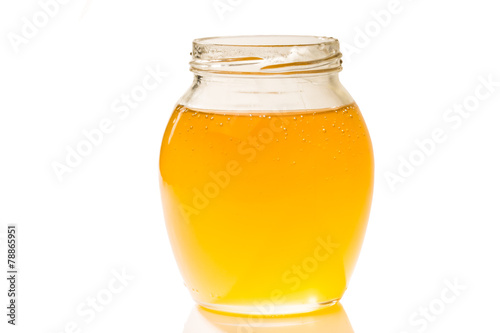 an image of jar of honey isolated on white background