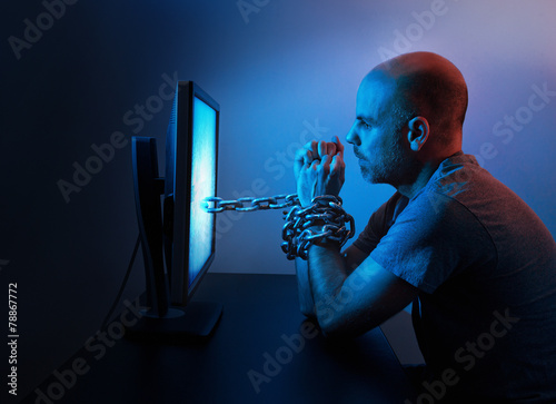 Man chained to computer photo