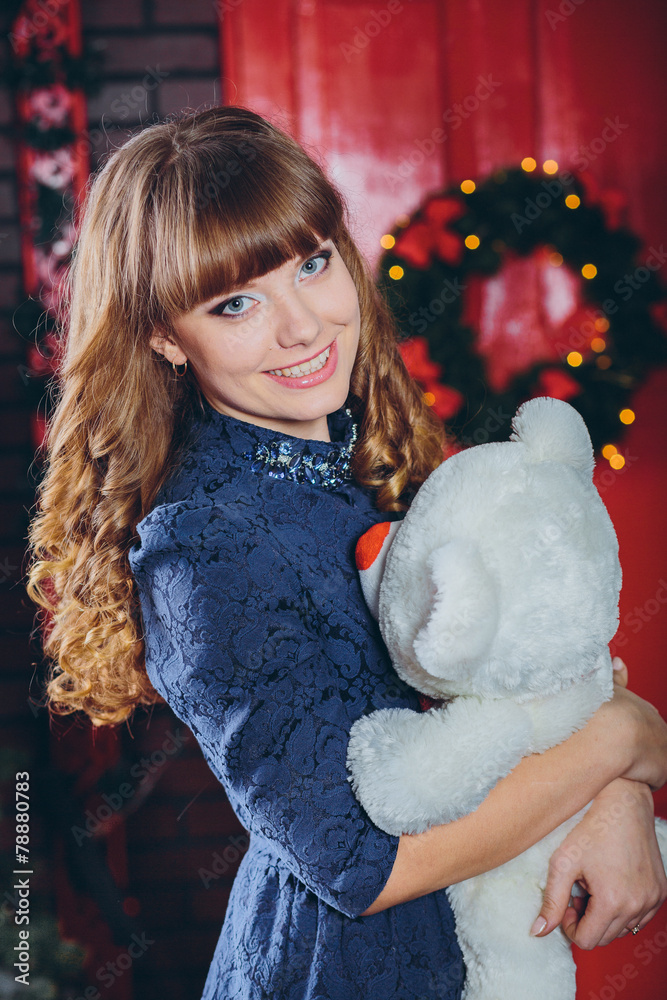Girl hugging a toy on Christmas on blurred background Girl hugging a toy on Christmas on blurred background