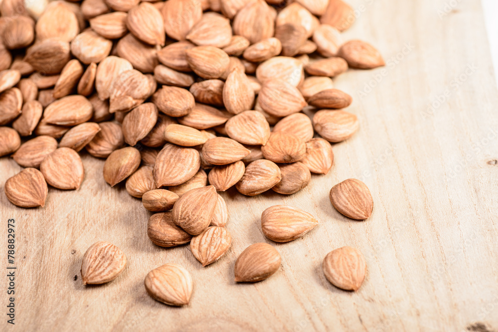 apricot kernels on the wooden board apricot kernels on the wooden board