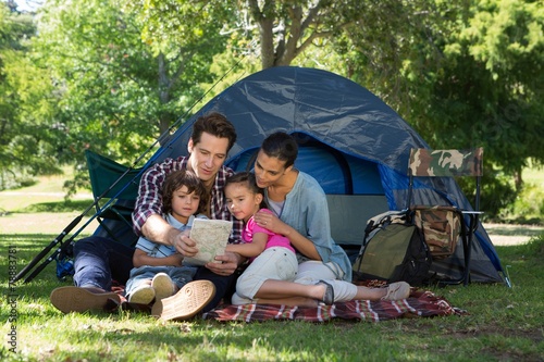 Happy family on a camping trip in their tent