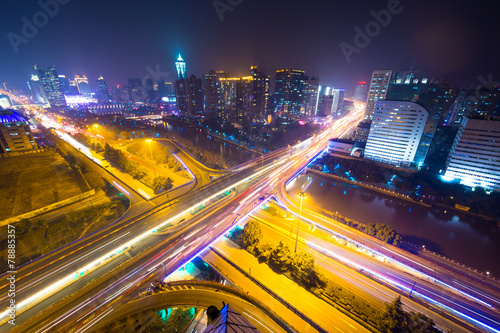 traffic light trails on overpass and cityscape at night © zhu difeng
