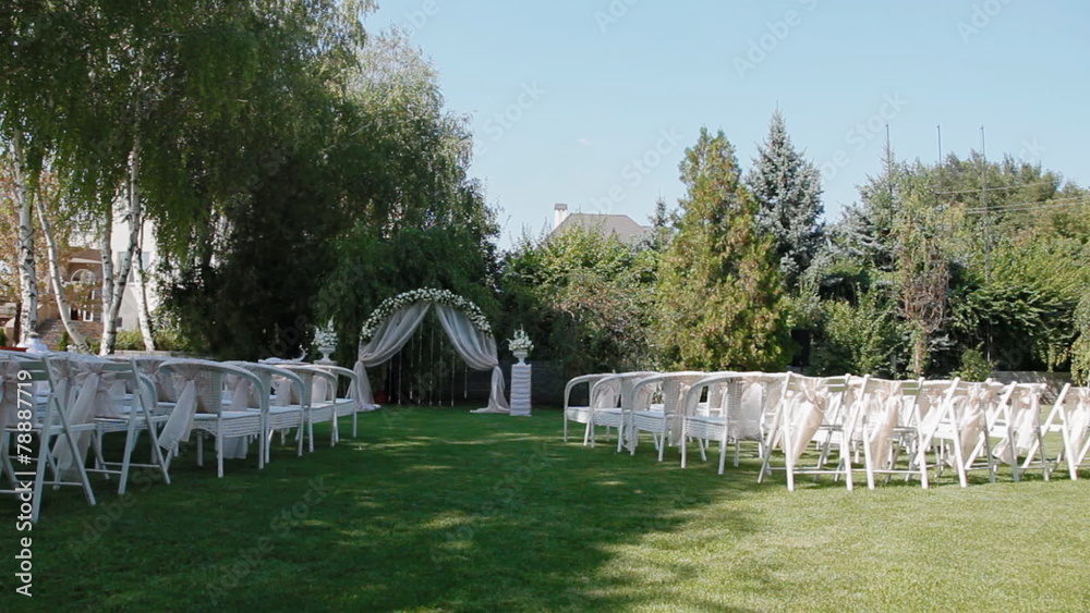 Wedding decoration with arch and white chairs Wedding decoration with arch and white chairs