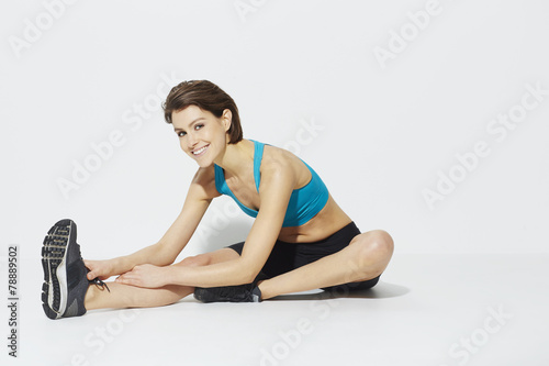 Beautiful woman stretching before exercise