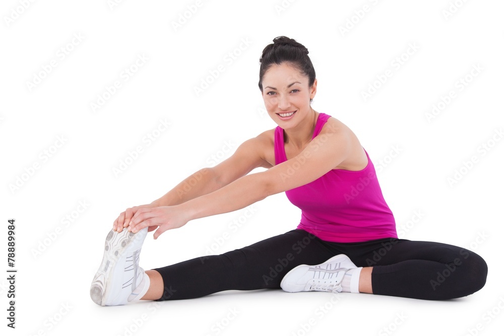 Fit woman stretching her legs