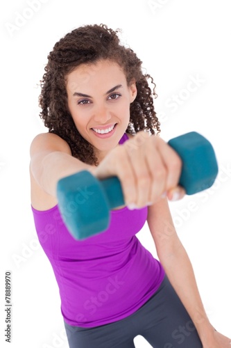 Fit woman lifting blue dumbbell