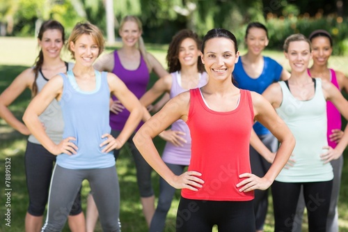 Fitness group smiling at camera in park