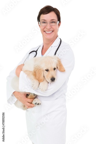 Fototapeta Naklejka Na Ścianę i Meble -  Smiling veterinarian with a cute dog in her arms