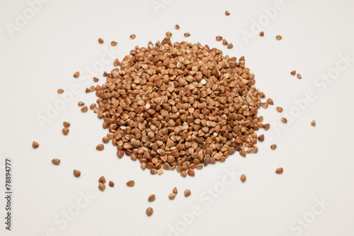 Buckwheat grains pile isolated on white background