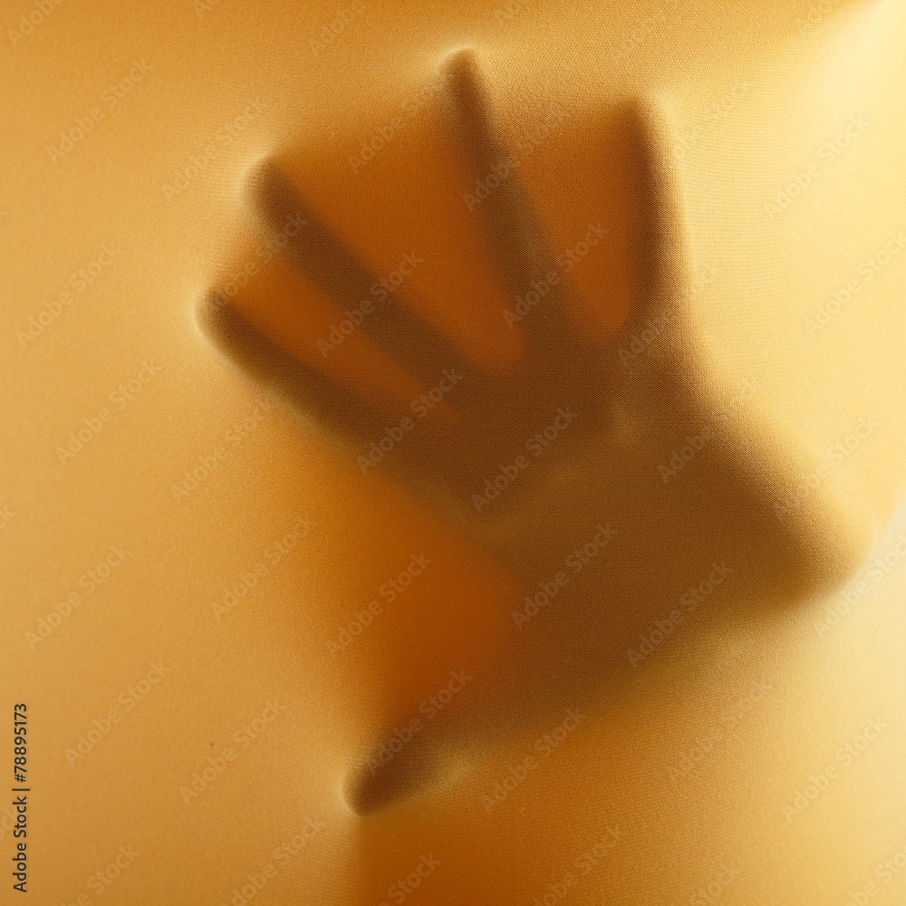 Fototapeta premium abstract hands, human arm inside yellow fabric, studio shot